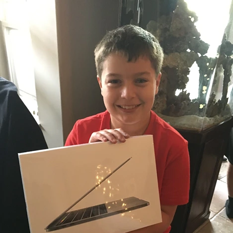 Noah with a MacBook.